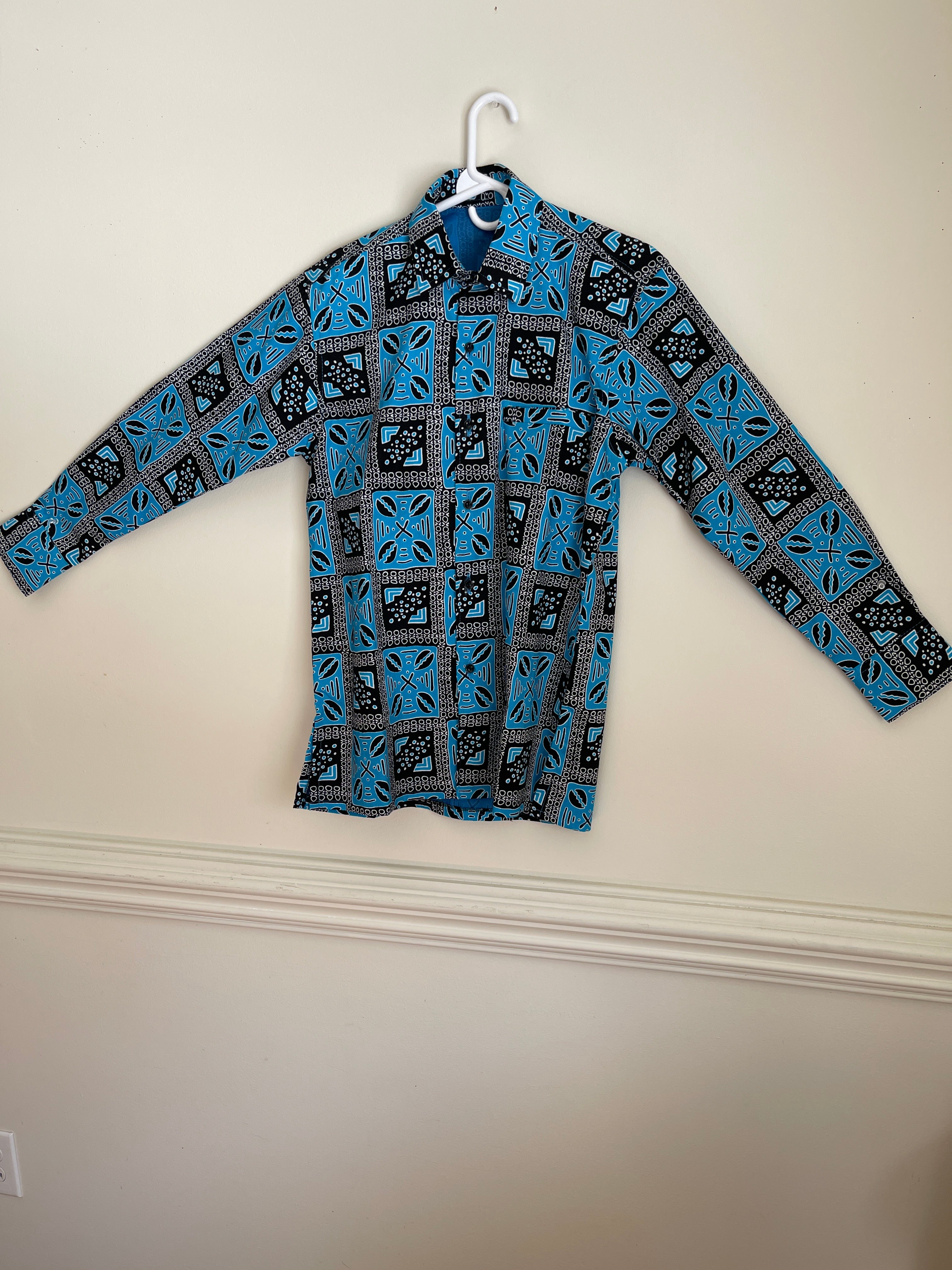 African dashiki shirt for men is a traditional garment originally from West Africa. Characterized by its vibrant colorful African prints. Typically made from cotton. This shirt is versatile for casual or formal wear